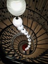 A unique spiral staircase with beautiful lights.