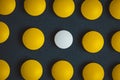 Unique white medicine pill among many yellow ones. Stand out of a crowd, individuality and difference concept. Leadership concept Royalty Free Stock Photo