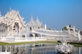 Unique white temple and popular tourist attraction in Chiang Rai known as Wat Rong Khun in the North of Thailand Royalty Free Stock Photo