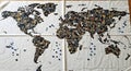 Unique world map crafted from diverse buttons on white fabric, symbolizing global connection Royalty Free Stock Photo