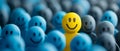 Human Resources Concept with a Unique Yellow Smiley Face Among Blue, Symbolizing the Right Person Standing Out in Royalty Free Stock Photo