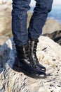 Unisex army black boots in military-style leather on laces for hiking in nature in the forest or mountains on a background Royalty Free Stock Photo