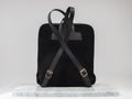 Luxury suet backbag. Luxury black leather and suet backpack on white background, on marble floor.