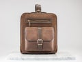 Luxury suet backbag. Luxury brown leather and suet backpack on white background, on marble floor.