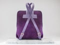 Unisex backbag. Luxury, purple leather and suet backbag on white background, on marble floor