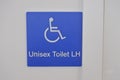 Unisex Toilet LH Sign with on a white wall