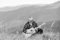In unison with nature. Musician hiker find inspiration in mountains. Keep calm and play guitar. Man with guitar on top Royalty Free Stock Photo