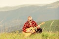 In unison with nature. Musician hiker find inspiration in mountains. Keep calm and play guitar. Man with guitar on top Royalty Free Stock Photo