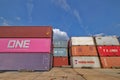 3-unit high stacked shipping containers against blue sky