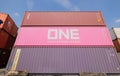 3-unit high stacked shipping containers soar into blue sky