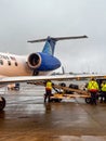 United Airlines baggage handlers loading cargo onto a commuter jet at Dulles International Royalty Free Stock Photo