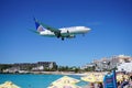 A United Airlines Boeing 737 lands over Maho Beach in St Martin