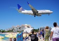 A United Airlines Boeing 737 lands over Maho Beach in St Martin