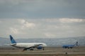 United Airlines jet and a Breeze Airways plane passing at the Airport in San Francisco.