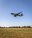 United Airlines plane flying over a park in Arlington before landing at Ronald Reagan Airport Royalty Free Stock Photo