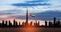 United Arab Emirates flag and Dubai skyline view at sunset. UAE celebration. Royalty Free Stock Photo