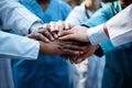 United and diverse multiethnic medical team joining hands in solidarity and cooperation