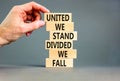 United or divided symbol. Concept words United we stand divided we fall on wooden blocks. Beautiful grey table grey background. Royalty Free Stock Photo