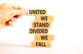 United or divided symbol. Concept words United we stand divided we fall on wooden blocks. Beautiful white table white background. Royalty Free Stock Photo