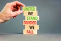 United or divided symbol. Concept words United we stand divided we fall on wooden blocks. Beautiful grey table grey background. Royalty Free Stock Photo