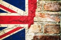 Brexit: United Kingdom UK flag flag painted cracked divided peeling paint brick wall cement facade Brexit concept. Royalty Free Stock Photo