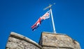 United Kingdom Union Jack flag blowing in the wind on top of Westgate Towers, Canterbury, UK. Royalty Free Stock Photo