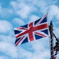 United Kingdom Union Jack Flag Flying Against A Blue Summer Sky Royalty Free Stock Photo