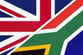 United Kingdom vs South Africa national flag from textile. Relationship between two European and African countries Royalty Free Stock Photo