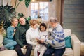 United large family watching photos while resting on the couch Royalty Free Stock Photo