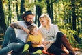 United with nature. Family day concept. Happy family with kid boy relaxing while hiking in forest. Mother father and