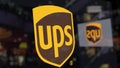 United Parcel Service UPS logo on the glass against blurred business center. Editorial 3D rendering