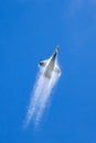 United Staes Air Force USAF Lockheed F-16CJ fighter aircraft climbing vertically with vapor pouring off the wings