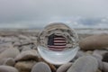 United States of America flag painted on a stone after a crystal ball on the beach Royalty Free Stock Photo