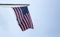 United States of America flag on a pole waving on blue sky background Royalty Free Stock Photo