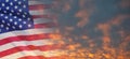 United States of America flag on sky at sunset or sunrise background.