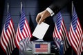United States of America flags, hand dropping ballot card into a box - voting, election concept Royalty Free Stock Photo