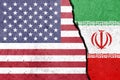 United States of America and Iran flags painted on the concrete wall. Royalty Free Stock Photo