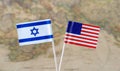 The United States of America and Israel flag pins on a world map background, political relations concept