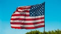 United States of America. US American Flag waving on a strong wind. Bright sunny day and deep blue color sky on background. Star s Royalty Free Stock Photo