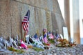 United States and Canadian flags, flowers and objects in memory of fallen in Normandy landing.