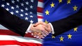 United States and EU handshake, international friendship, flag background Royalty Free Stock Photo