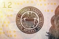 United States Federal Reserve System symbol from hundred dollar bank note. Close up shot with sun beams effect Royalty Free Stock Photo