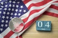 United states flag with crystal glass globe and wooden calendar on wood background Royalty Free Stock Photo