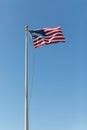 United states flag flowing with a wind on a blue sky background Royalty Free Stock Photo