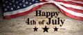 United States flag with happy 4th of July message placed on wooden background. 3d illustration