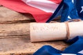 United States flag and rolled-up Constitution.