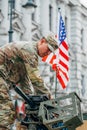 United States Marine Corps soldier on the top of a military vehicle mounting a machine gun with American flagAmerican flag Royalty Free Stock Photo