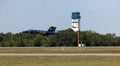United States Navy Blue Angel fighter jet flying low over an airport during an airshow in Florida Royalty Free Stock Photo