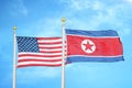 United States and North Korea two flags on flagpoles and blue cloudy sky Royalty Free Stock Photo