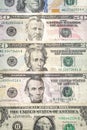 United States paper currency or cash layed fanned out on a table starting with a one dollar bill, five dollar bill, twenty, fifty